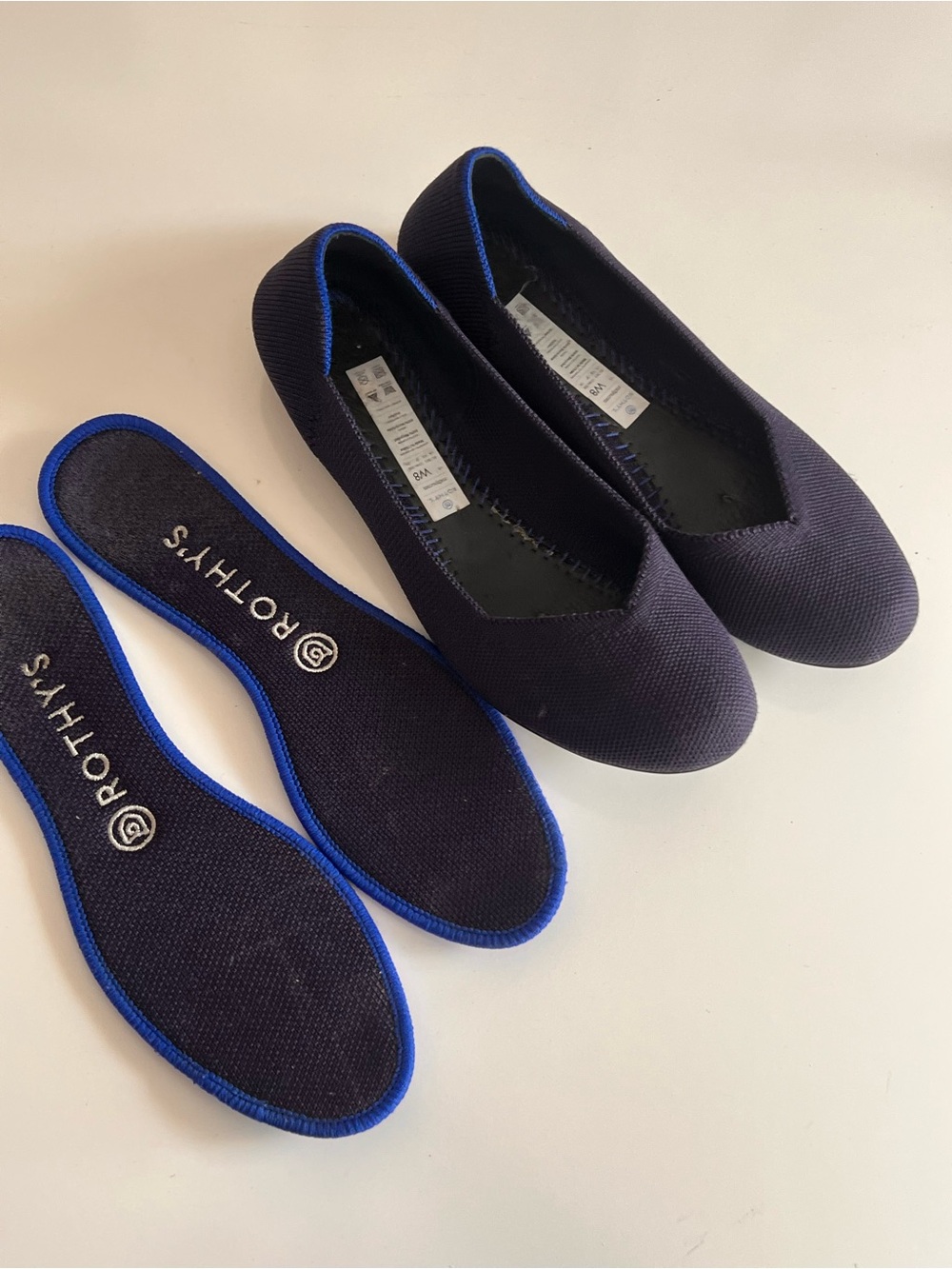 Rothy's navy blue round-toe knit flat shoes featuring a distinctive bright blue - Picture 6 of 12